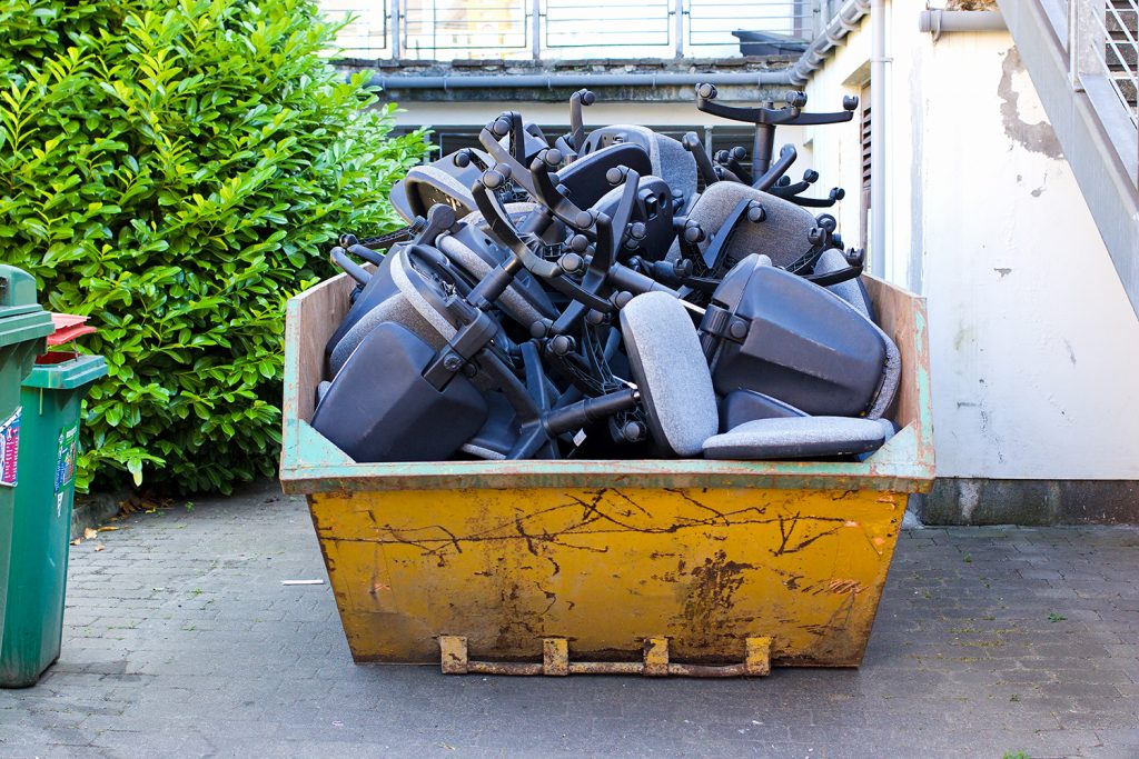 Skip full of desk chairs