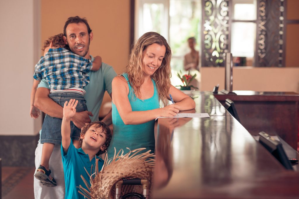 Family at hotel reception checking in